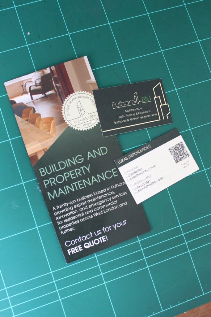 Fulham BM printed brochure and business cards featuring the Building and Property Maintenance branding, arranged on a designer's cutting mat